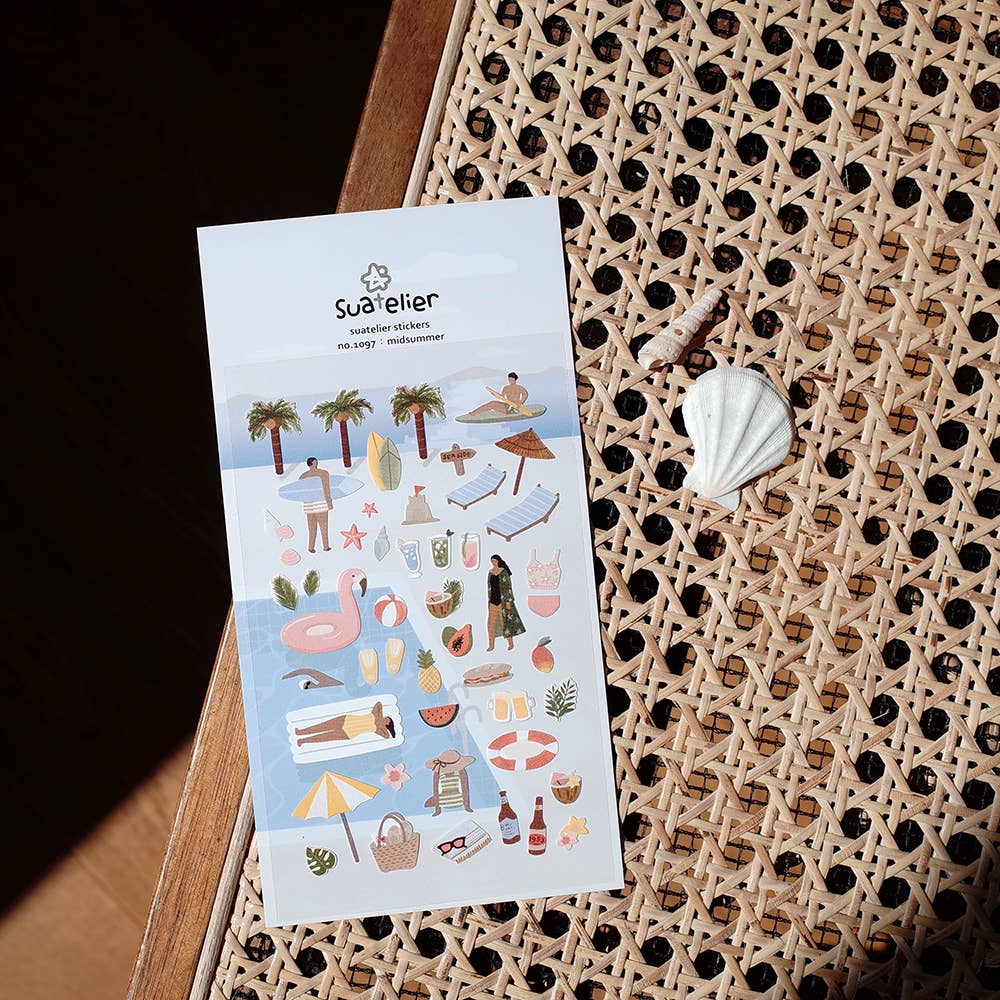 Sheet of stickers with beach-themed designs on a textured surface