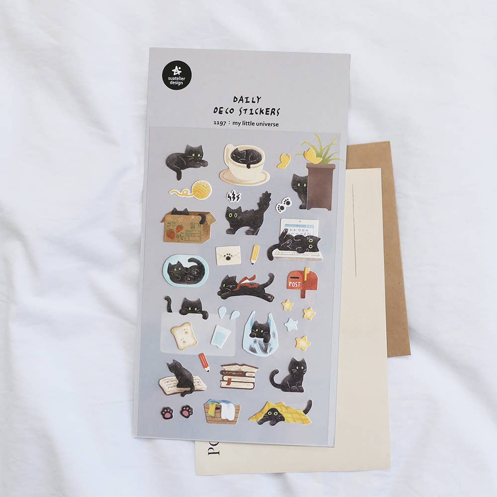 Sheet of black cat stickers with a brown envelope on a white background