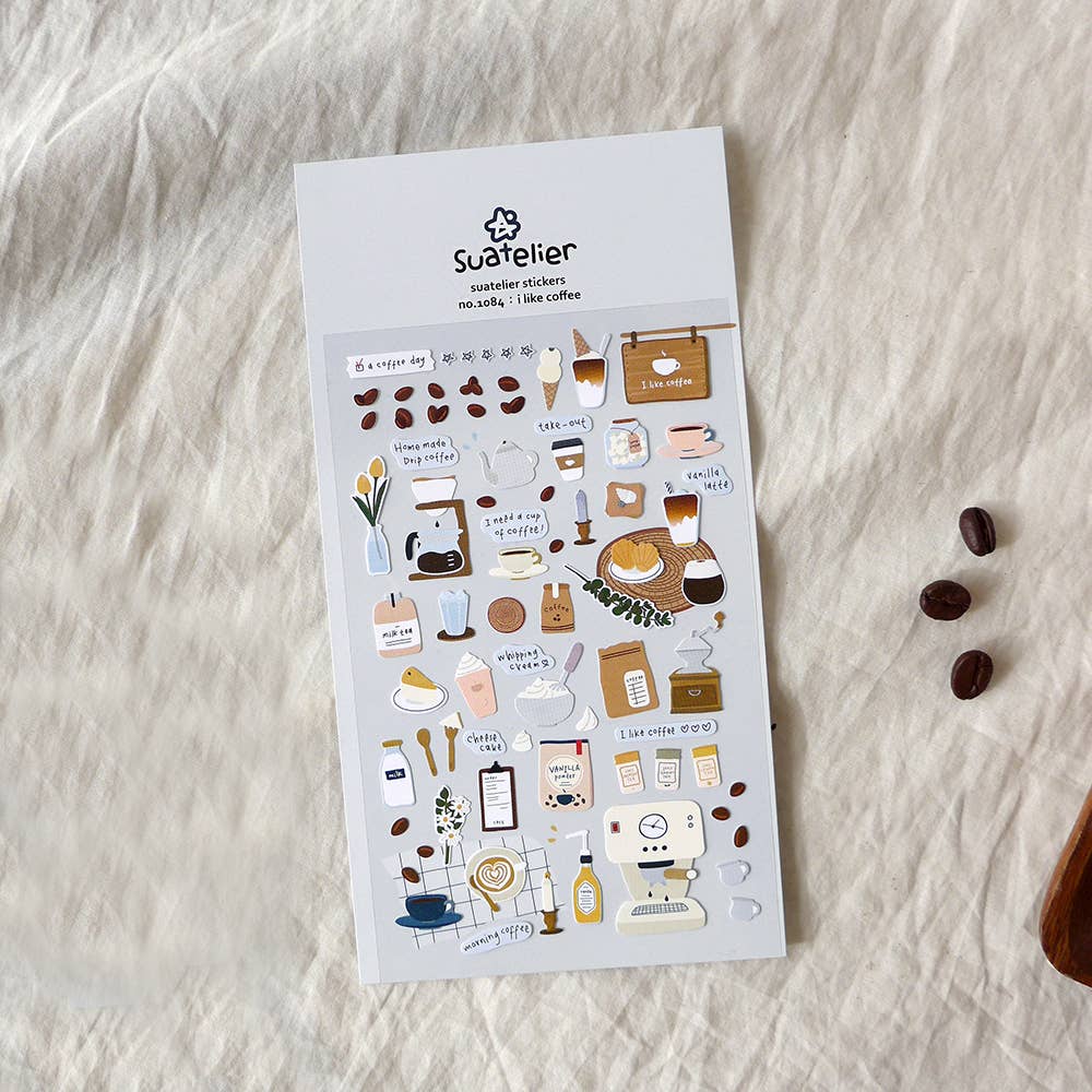 Sticker sheet with coffee-themed designs on a textured white surface