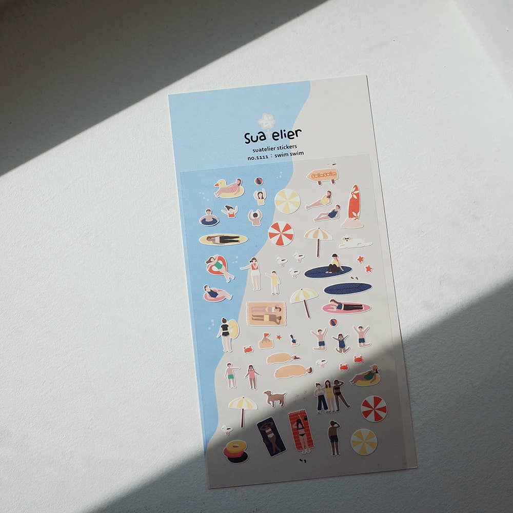 Sheet of decorative stickers with various illustrations on a light surface