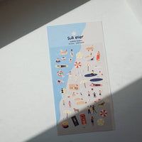 Sheet of decorative stickers with various illustrations on a light surface