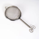 Metallic tea strainer on a white background