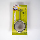 Stainless steel tea strainer on a green packaging with Japanese text
