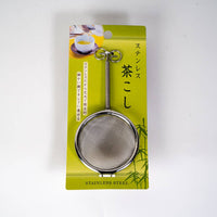 Stainless steel tea strainer on a green packaging with Japanese text