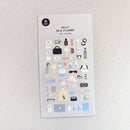 Sheet of decorative stickers with various small illustrations on a textured surface