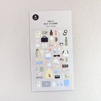 Sheet of decorative stickers with various small illustrations on a textured surface