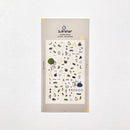 Packaging of Suqqu stickers with various designs on a light gray background