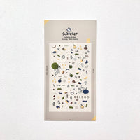 Packaging of Suqqu stickers with various designs on a light gray background
