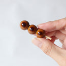 Mitarashi dango ceramic chopstick rest held in a hand