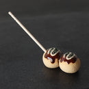 Takoyaki ceramic chopstick rest with a toothpick inserted