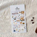 Sticker sheet with coffee-themed designs on a textured white surface