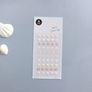 Sheet of decorative stickers with starfish and shell designs on a gray background