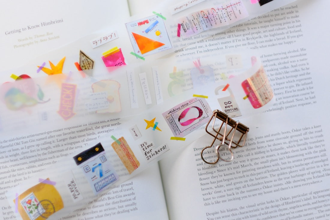 Collection of colorful stationery items on an open book