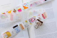 Collection of colorful stationery items on an open book